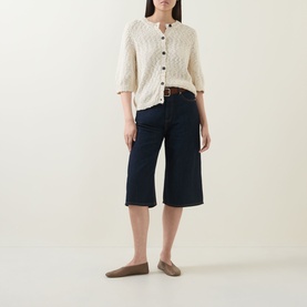 Model wearing InWear Glenn Culotte Jeans in Dark Denim, wide-leg mid-rise style with clean hems, styled with cream knit cardigan and taupe flats.