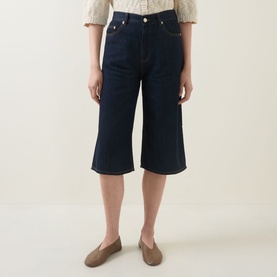 Model wearing InWear Glenn Culotte Jeans in Dark Denim, mid-rise wide-leg culotte cut with five-pocket styling and clean hems, styled with flat shoes.