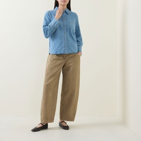 Model wearing InWear Bleach Denim shirt in cotton-lyocell, styled with wide-leg tan trousers and black ballet flats.