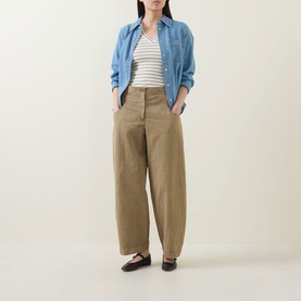 Model wearing InWear Bleach Denim shirt in cotton-lyocell, styled with striped top, wide-leg khaki trousers and dark loafers.