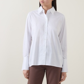 Model wearing InWear Vex Pleated Shirt in Pure White with pointed collar, button front, and long sleeves, styled with brown trousers.