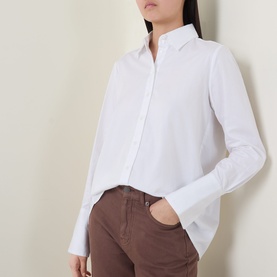 Model wearing InWear Vex Pleated Shirt in Pure White with pointed collar and button fastening, styled with brown trousers.