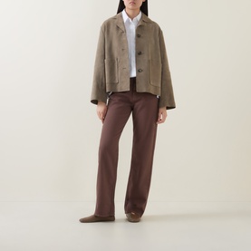 Model wearing InWear Vex Pleated Shirt in Pure White with pointed collar, styled with taupe jacket and brown wide-leg trousers.