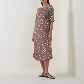 Model wearing InWear Brown Bru polka dot midi skirt in viscose, styled with matching top and tan strappy flat sandals.