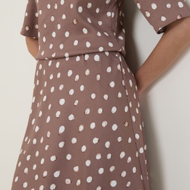Model wearing InWear brown polka dot viscose skirt, styled with matching cropped top in the same print.