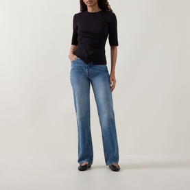 Model wearing InWear Far Vincent Ruched T-Shirt in black with ruched front detail, styled with light blue wide-leg jeans and dark loafers.