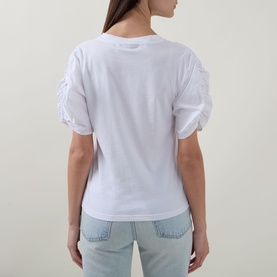 Model wearing InWear Gudrun Puff T-Shirt in Pure White, back view showing ruched puff sleeves and straight hem, styled with light blue jeans.