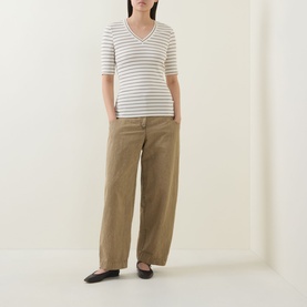 Model wearing InWear Dagnal Striped T-Shirt in Vanilla/Coffee Q, V-neckline, short sleeves, styled with wide-leg tan trousers and black flats.