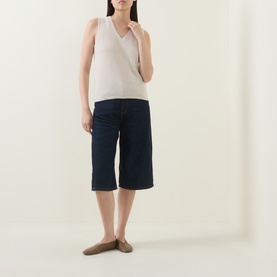 Model wearing InWear Deva Knitted Vest in Ecru with V-neckline, styled with navy wide-leg shorts and tan loafers.