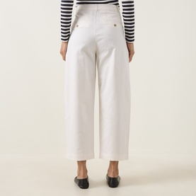 Model wearing InWear Elvia Wide Leg Trousers in Vanilla, wide-cut silhouette, styled with black loafers and a striped top, rear view.