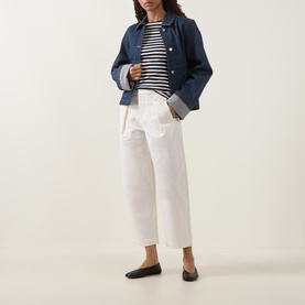Model wearing InWear Elvia Wide Leg Trousers in Vanilla with pleat details, styled with a striped top, denim jacket and black ballet flats.