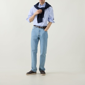 Model wearing Kempt Stripe Single-Cuff Shirt in blue white, styled with light wash jeans, brown belt, and navy scarf.