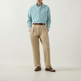 Model wearing Kempt Green White Stripe Single-Cuff Shirt with button-down collar, styled with beige chinos and brown loafers.