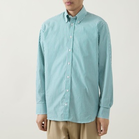 Model wearing Kempt Stripe Single-Cuff Shirt in green and white, featuring button-down collar and long sleeves, styled with beige trousers.