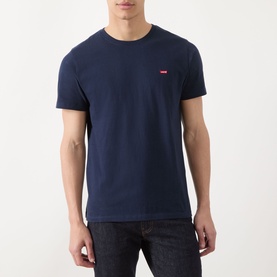 Model wearing Levis Original Housemark Logo T-Shirt in blue, crew neck, short sleeves, small red logo at chest, styled with dark jeans
