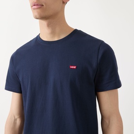 Model wearing Levis Original Housemark Logo T-Shirt in blue, crew neck with small red batwing logo on chest, short sleeves.