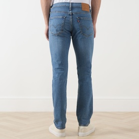 Model wearing Levis 511 Slim Leg Jeans in A Step Ahead blue, rear view showing branded badge, five pockets and signature logo tab.