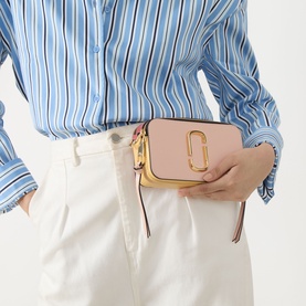 Model carrying Marc Jacobs The Colourblock Chain Snapshot crossbody in Rose Multi with gold-toned hardware, styled with a blue striped shirt and