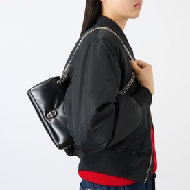 Model carrying Marc Jacobs Scene Chain Mini Bag in black leather with gun-metal hardware and chain detail, styled with black bomber jacket