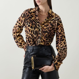 Model carrying Marc Jacobs Scene Small Shoulder Bag in black leather with gold-toned hardware, styled with leopard print shirt and black leather