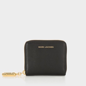 Marc Jacobs The Scene Slim Compact Wallet in black leather with gold-tone zip-around fastening, statement charm, and embossed logo detail