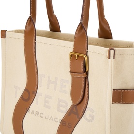 Marc Jacobs The Wavy Canvas Large Tote Bag in beige canvas with argan oil leather trim, gold-tone buckle hardware and logo lettering detail