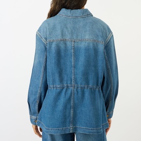 Model wearing Paige jacket in La Verne blue denim, rear view showing cinched waist, contrast stitching and relaxed fit
