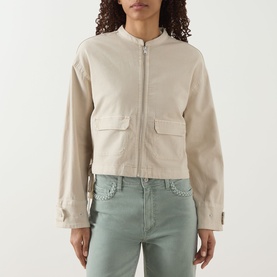 Model wearing Paige jacket in Vintage Biscotti, zip-front with patch pockets, styled with sage green jeans