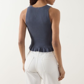 Model wearing Paige Pacific Blue ribbed knit tank with frill hem, styled with white jeans, seen from behind