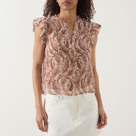 Model wearing Paige silk top in Antique White Multi paisley print with ruffle flutter sleeves and V-neckline, styled with white jeans