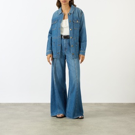 Model wearing Paige Wide Leg Jeans in La Verne denim, styled with matching denim jacket and white top