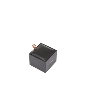 Paul Smith Access gold brass cufflink displayed in black branded gift box, copper-tone loop detail visible from above