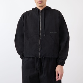 Model wearing Robyn Lynch black cotton casual jacket with zip front and hood, styled with matching black trousers