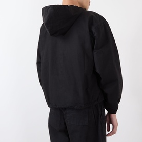 Model wearing Robyn Lynch black cotton casual jacket with hood, shown from behind, styled with matching black trousers