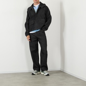 Model wearing Robyn Lynch black denim casual jacket with hood, styled with matching black trousers and grey trainers.