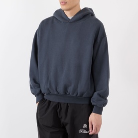 Model wearing Robyn Lynch slate blue cotton hoodie, styled with black branded joggers