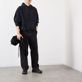 Model wearing Robyn Lynch Ireland Logo Embroidered Hoodie in slate blue with black wide-leg trousers and black chunky trainers, carrying a black bag.