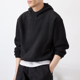Model wearing Robyn Lynch black oversized pullover hoodie with drop shoulders, styled with matching black joggers