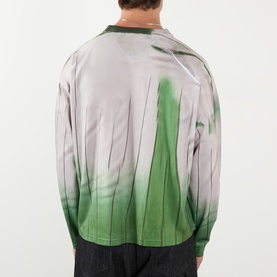 Model wearing Robyn Lynch green long-sleeve T-shirt, back view, with abstract botanical print in grey and green tones.