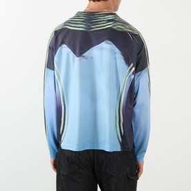 Model wearing Robyn Lynch blue long-sleeve T-shirt, rear view, with abstract graphic print in dark navy and light blue tones.