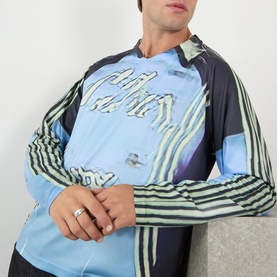 Model wearing Robyn Lynch blue long-sleeve T-shirt with abstract graphic print in black, green and white tones