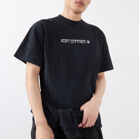 Model wearing Robyn Lynch Skint Logo T-Shirt in off black with high crew neck, dropped shoulders, and front logo graphic.