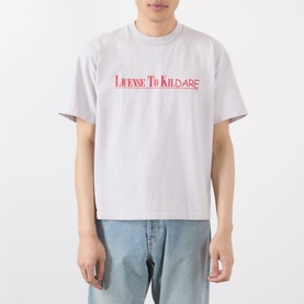 Model wearing Robyn Lynch grey cotton T-shirt with red License To Kildare slogan print, styled with light blue jeans.