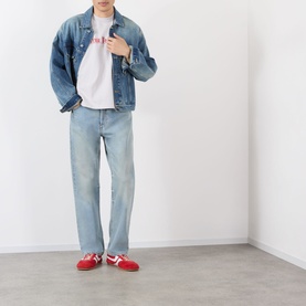 Model wearing Robyn Lynch grey cotton T-shirt with denim jacket, light-wash jeans and red trainers.