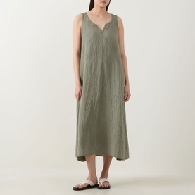Model wearing Transit green sleeveless maxi dress with V-neckline and relaxed fit, styled with brown flat sandals.
