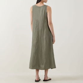 Model wearing Transit green sleeveless midi dress with relaxed silhouette, shown from the back, styled with black flat sandals.