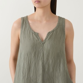 Model wearing Transit green sleeveless dress with V-neck and delicate lace trim detail, in viscose, polyamide and linen blend