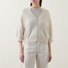 Model wearing Transit Zip Knit Cardigan in sand, V-neckline, three-quarter sleeves, layered over crochet top with white trousers