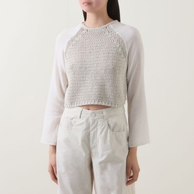 Model wearing Transit sand cropped knit top with open-weave front panel and raglan sleeves, styled with light grey trousers