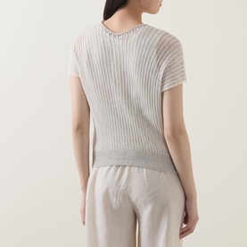 Model wearing Transit white/sand ribbed cotton-linen knit top, back view, styled with beige wide-leg trousers